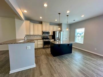 Greenville house for rent - a kitchen with white cabinets and a black counter top