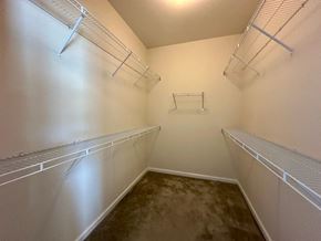 Greenville house for rent - a spacious closet with shelves and hanging racks