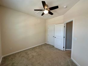 Greenville house for rent - a bedroom with carpet and a ceiling fan