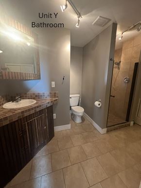 Grinnell apartment for rent - A bathroom with a sink, toilet, and shower.