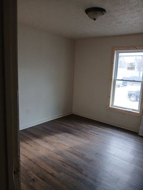 Louisville apartment for rent - A room with a window and wooden floors.