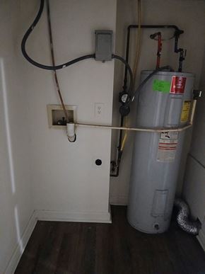 Louisville apartment for rent - A grey water heater with a yellow tape on it.