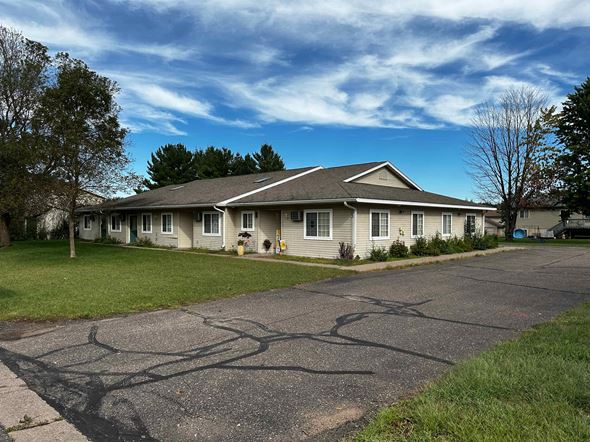 Menomonie apartment for rent - a white house with a driveway and grass