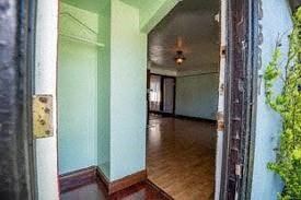 Victoria apartment for rent - an empty room with green walls and a wood floor