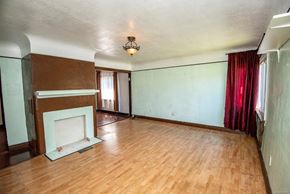 Victoria apartment for rent - an empty living room with a fireplace and a wooden floor