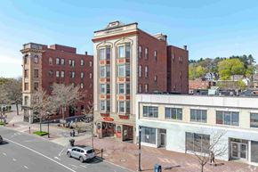 New Britain apartment for rent - A street view of a city with a large building in the middle.