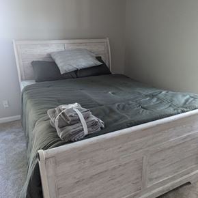 Cary apartment for rent - a bedroom with a bed and a blanket and pillows