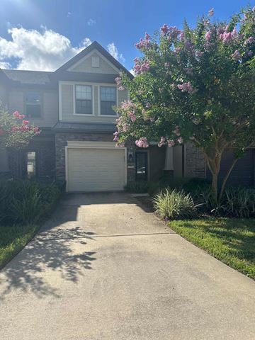 Jacksonville house for rent - a driveway in front of a house with a garage door