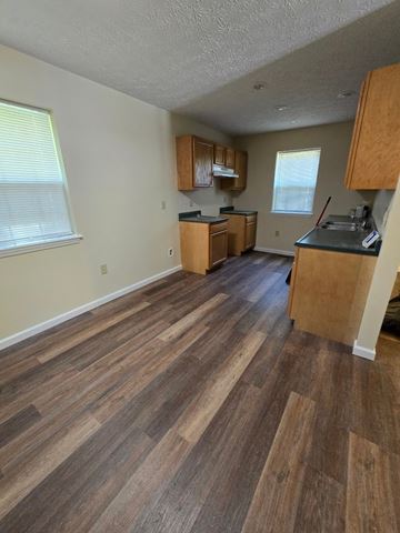 Morehead house for rent - an empty kitchen with wooden floors and wooden cabinets