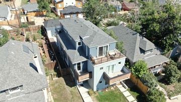 Denver house for rent - an aerial view of a house with a roof and a deck