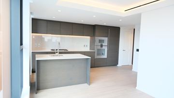Vancouver apartment for rent - A modern kitchen with a sink and a refrigerator.