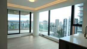 Vancouver apartment for rent - A modern kitchen with a view of the cityscape outside the large windows.