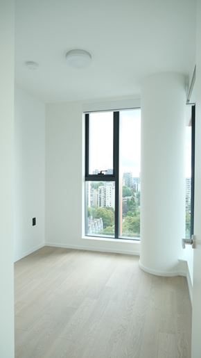 Vancouver apartment for rent - A white room with a large window and wooden flooring.