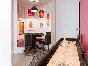 Dorchester apartment for rent - a dining room with a long table and chairs and a wall of art