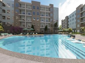 Charlotte apartment for rent - an outdoor pool with an apartment building in the background