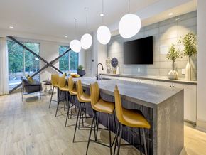 Charlotte apartment for rent - a kitchen with a marble counter top and yellow chairs