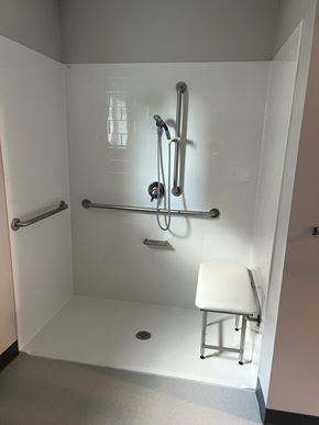 Agawam apartment for rent - A white shower stall with a shower head and hand held shower.