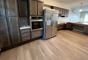 Agawam apartment for rent - A kitchen with a refrigerator, oven, and cabinets.
