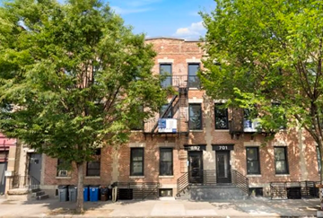 Brooklyn apartment for rent - a brick apartment building with trees in front of it