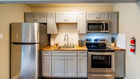 Albuquerque apartment for rent - A modern kitchen with a stainless steel refrigerator, oven, and cabinets.