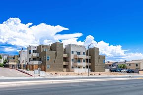 Albuquerque apartment for rent - A modern apartment complex with a clear blue sky above.