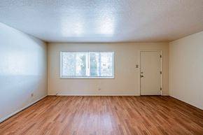 Albuquerque apartment for rent - A room with wooden floors and a window with blinds.