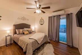 Albuquerque apartment for rent - A bedroom with a large bed and a ceiling fan.