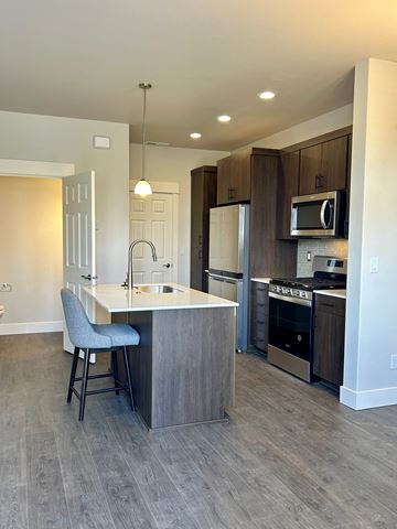 Bend apartment for rent - a kitchen with an island and stainless steel appliances