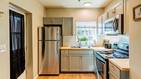 Albuquerque apartment for rent - A kitchen with a stainless steel refrigerator and oven.