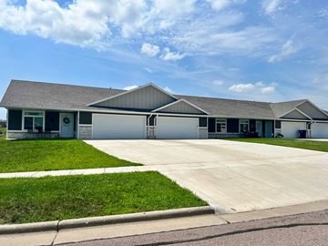 Dell Rapids apartment for rent - the front of a house with a driveway and grass