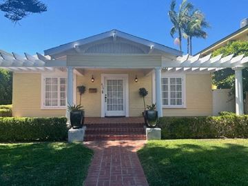 Coronado house for rent - a yellow house with a white porch and a walkway