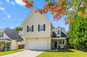 Fuquay-Varina house for rent - a yellow house with a white garage door
