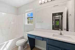 Fuquay-Varina house for rent - a bathroom with a sink and a toilet and a mirror