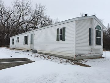 Manvel house for rent - a white house with green shutters in the snow