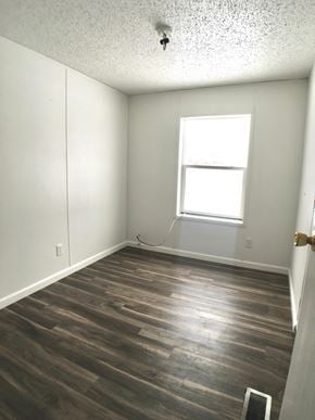 Manvel house for rent - an empty room with wood floors and a window