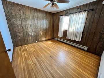 Grand Forks house for rent - a living room with wood flooring and a ceiling fan