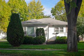 Grand Forks house for rent - a small white house with a yard and trees