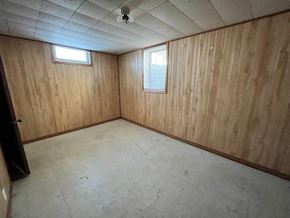 Grand Forks house for rent - the bonus room has a concrete floor and wood walls