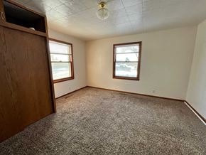 Manvel house for rent - a bedroom with a wardrobe and a carpeted floor