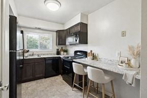 Baltimore apartment for rent - an updated kitchen with black appliances and granite counter tops