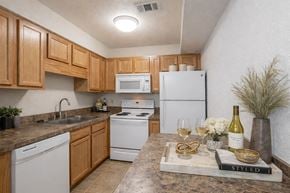 Jacksonville apartment for rent - a kitchen with white appliances and wooden cabinets