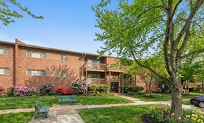 Baltimore apartment for rent - a kitchen with black appliances and wooden cabinets