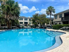Jacksonville apartment for rent - a dining room with a view of the water and a table and chairs