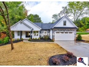 Loudon house for rent - A white house with Key Properties LLC written on it.