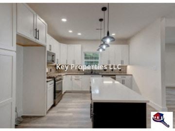 Loudon house for rent - A modern kitchen with Key Properties LLC watermark.