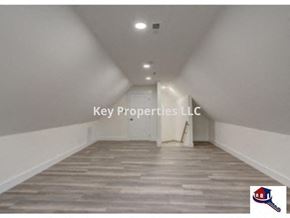 Loudon house for rent - Key Properties LLC logo on a white wall in a long hallway.