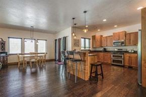Whitefish house for rent - a large kitchen and dining area with a table and chairs