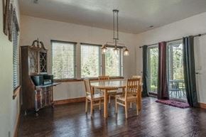 Whitefish house for rent - a dining room with a wooden table and chairs