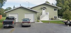 Anchorage apartment for rent - A house with a garage and a truck parked in front.