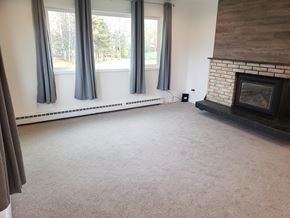 Anchorage apartment for rent - A living room with a fireplace and a large window.